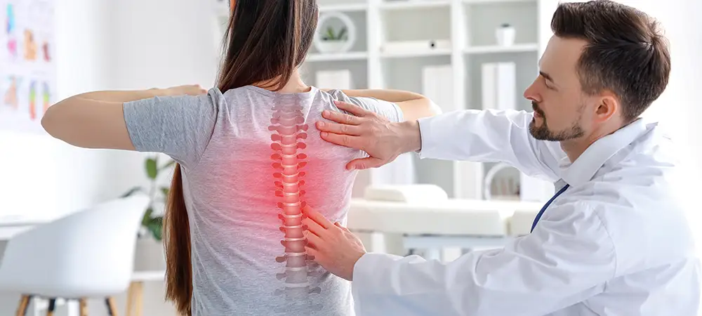 Doctor examining woman's spine